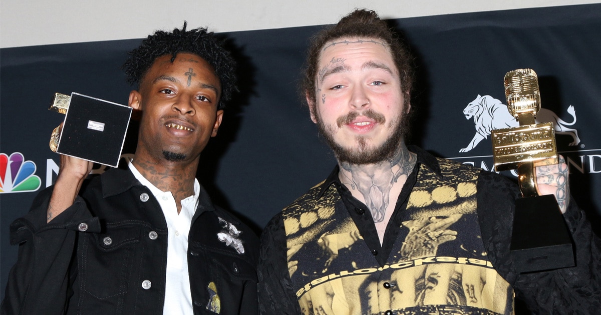 rapper 21 savage stands next to post malone at the billboard music awards