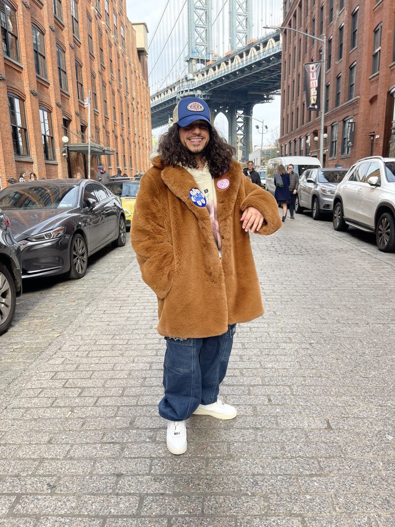 Russ in a fur jacket on the street.