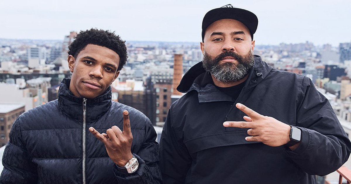 Rapper A Boogie wit da Hoodie posing next to radio host Ebro 