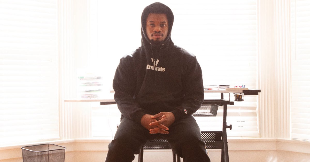 rapper denzel curry sits on chair for vans sneaker collaboration