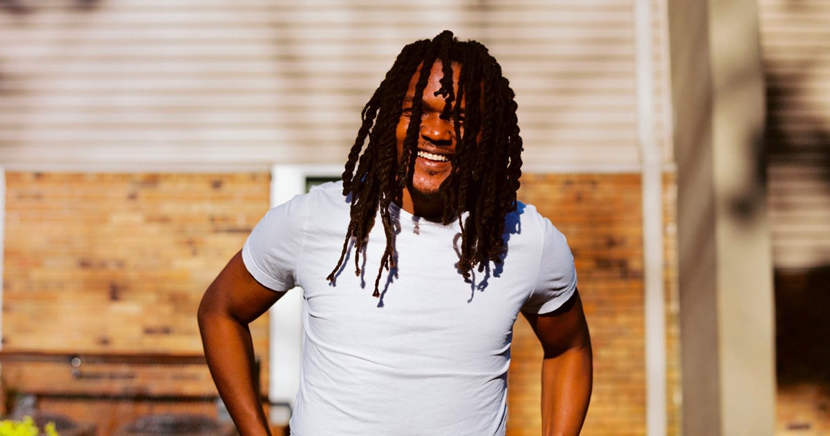 rapper young nudy smiles, wearing white shirt, in atlanta