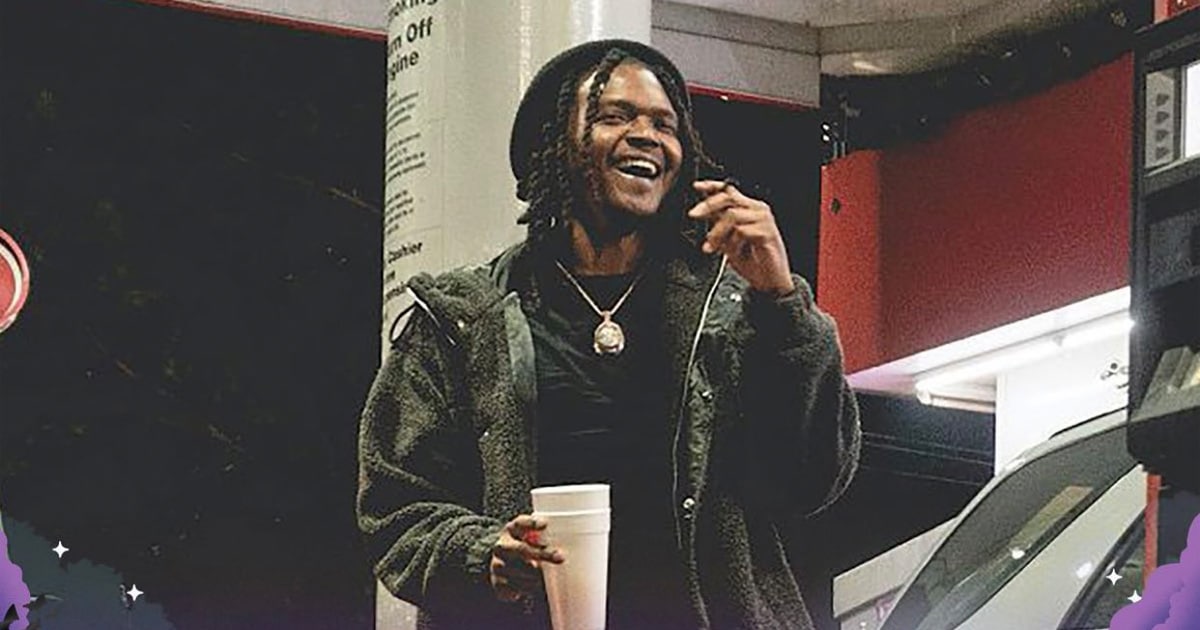 rapper young nudy stands at gas station holding styrofoam cup