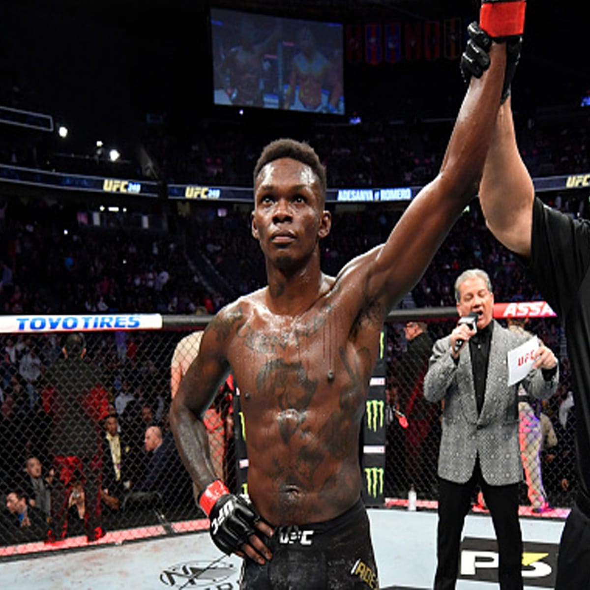 ufc middleweight israel adesanya raises arm after defeating yoel romero