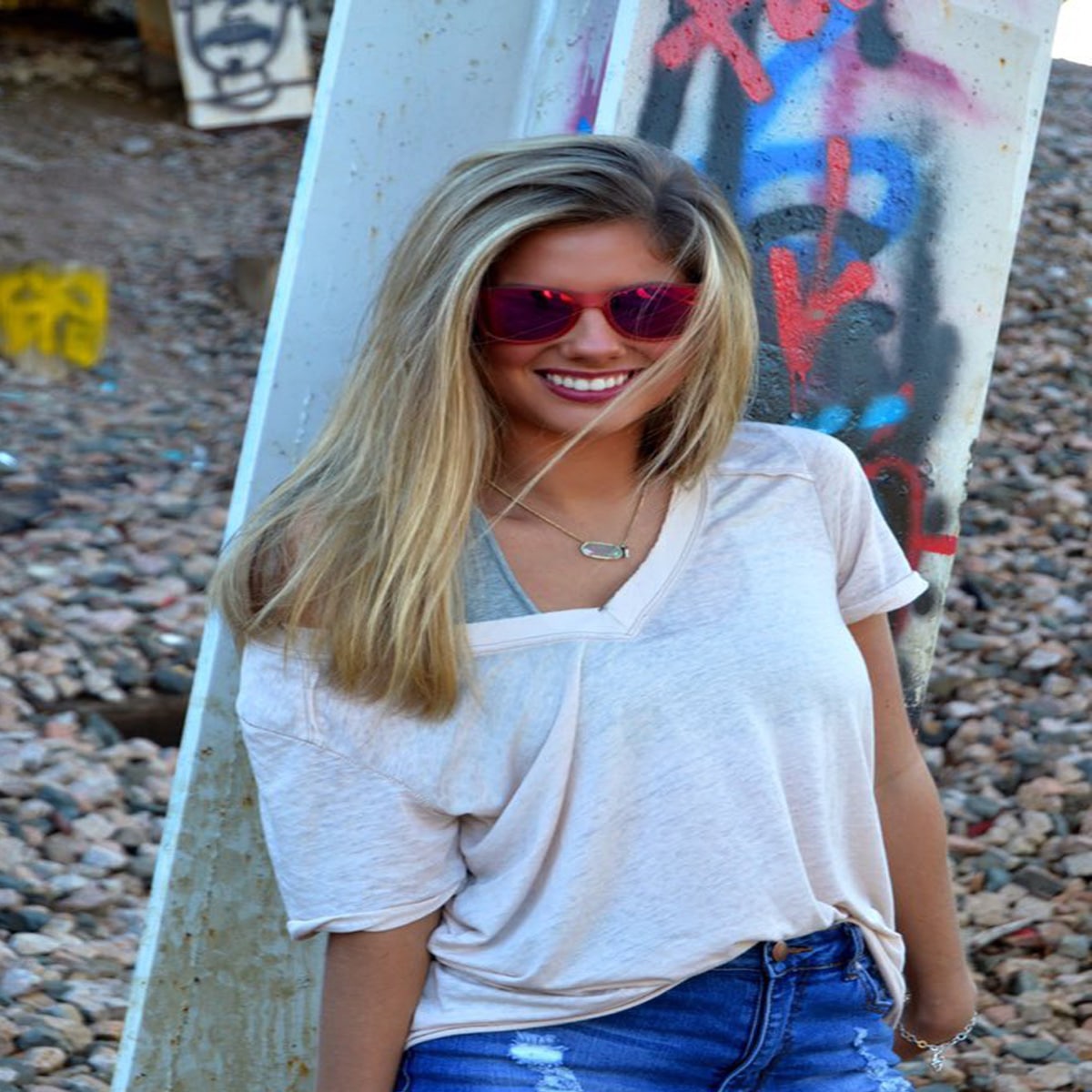 internet personality rachel gomber wearing sunglasses on the beach