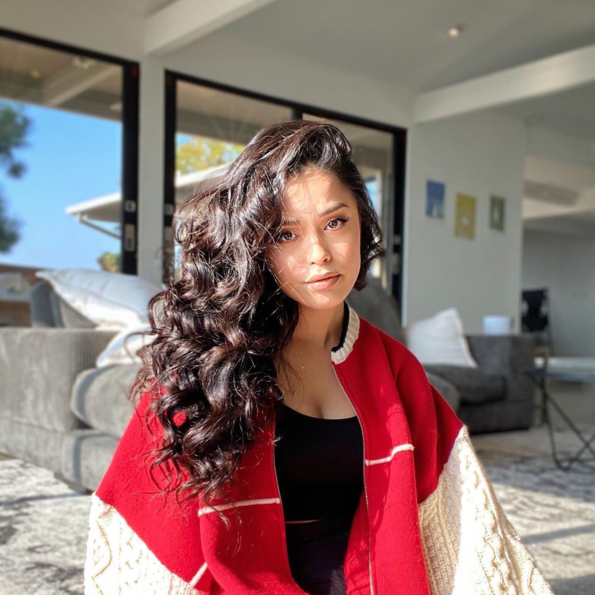 internet personality valkyrae poses in red sweater