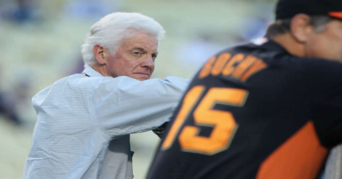 Bill Neukom (L) looks over at manager Bruce Bochy prior to the start of the game 