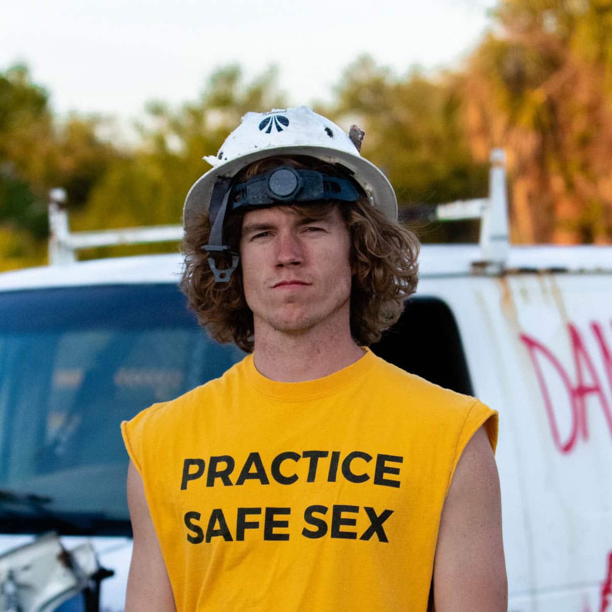 youtuber danny duncan poses with helmet and yellow shirt