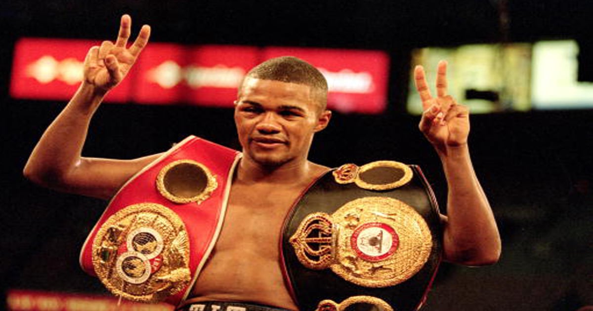 richest boxers Felix Trinidad celebrates in the ring with his belts