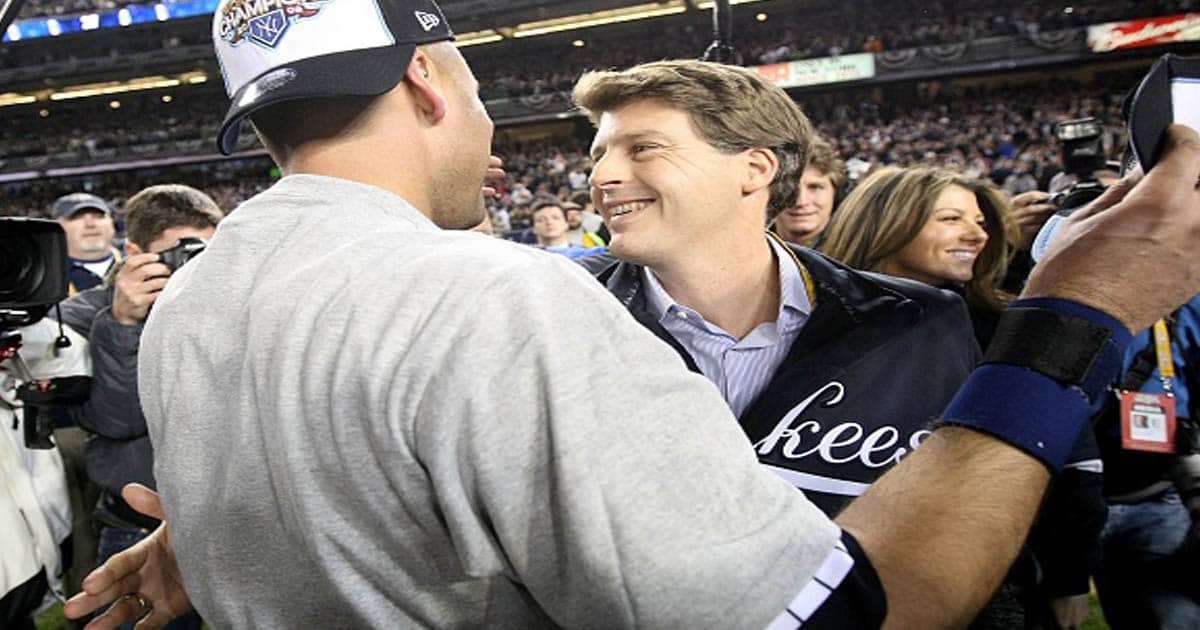 Hal Steinbrenner of the New York Yankees celebrates with the Derek Jeter #2 