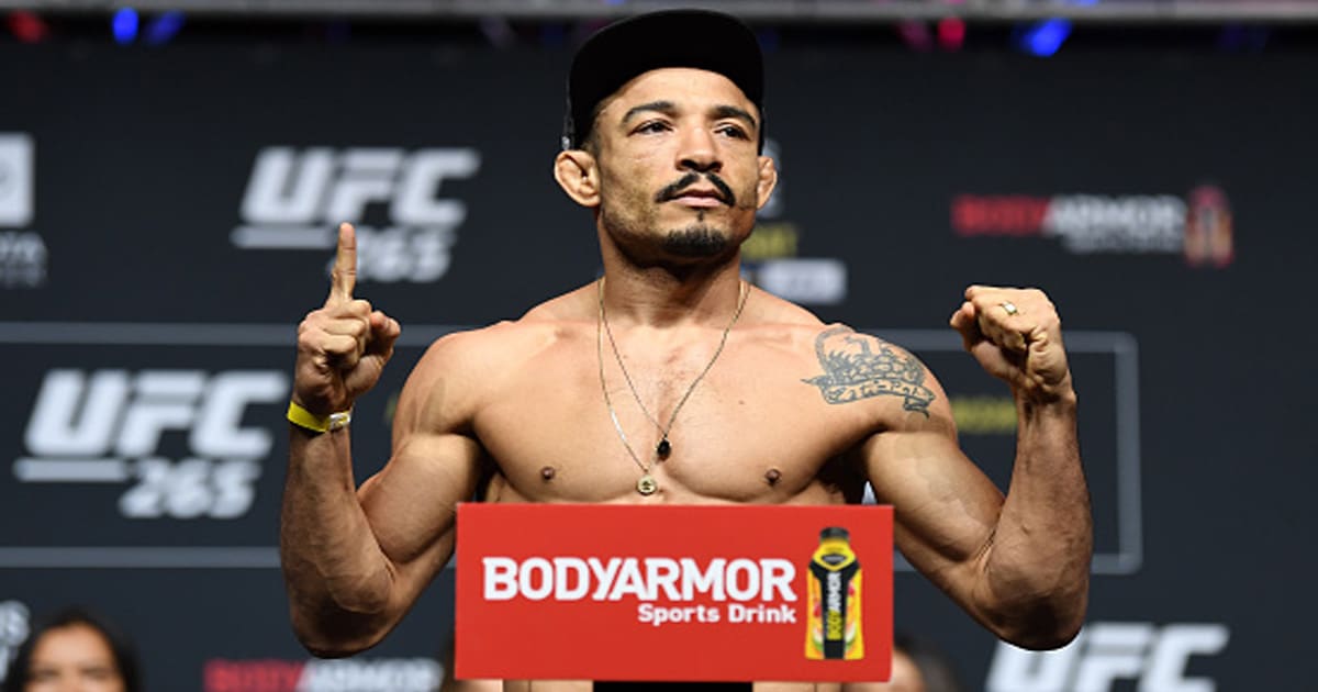 Jose Aldo poses on the scale during the UFC 265 ceremonial weigh-in