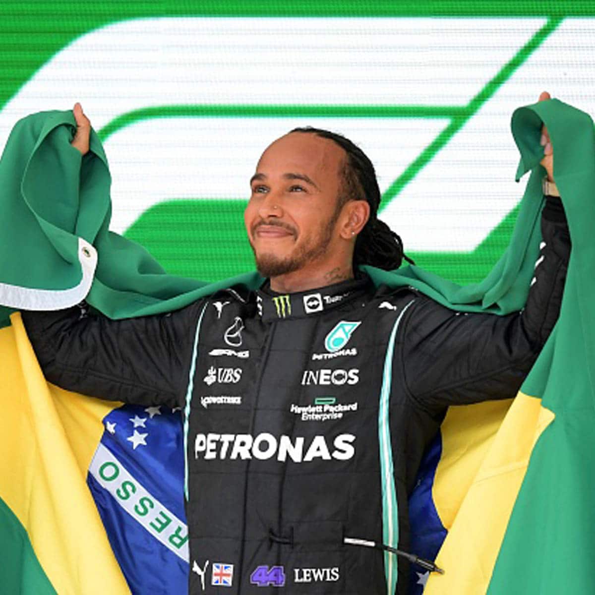 driver lewis hamilton celebrates on the podium after winning race