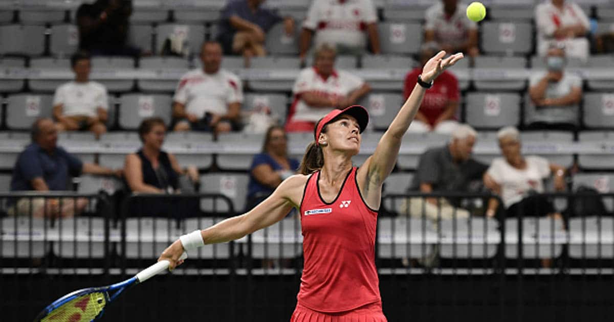 martina hingis throws ball up for serve