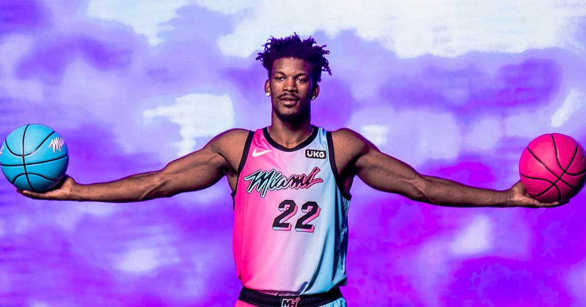 miami heat forward jimmy butler poses in uniform with two basketballs