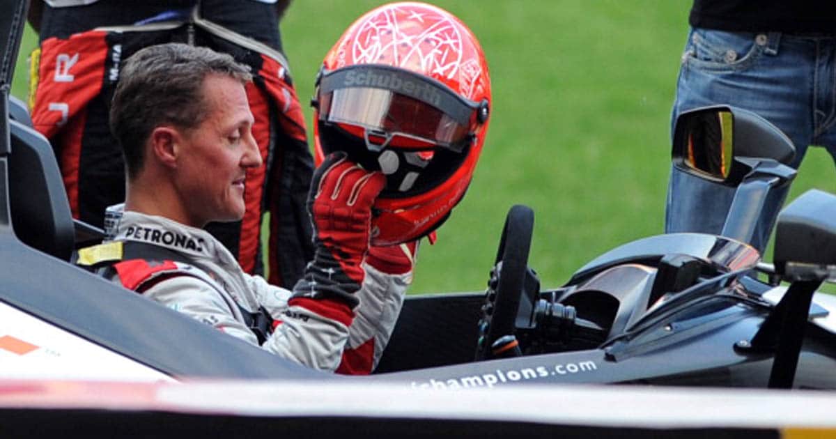 richest race drivers Michael Schumacher (L) puts on a helmet during a practice session ahead of the annual Race of Champions