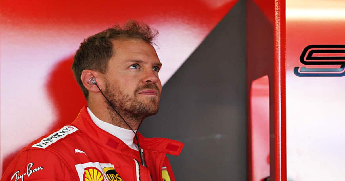 Sebastian Vettel of Germany and Ferrari prepares to drive in the garage