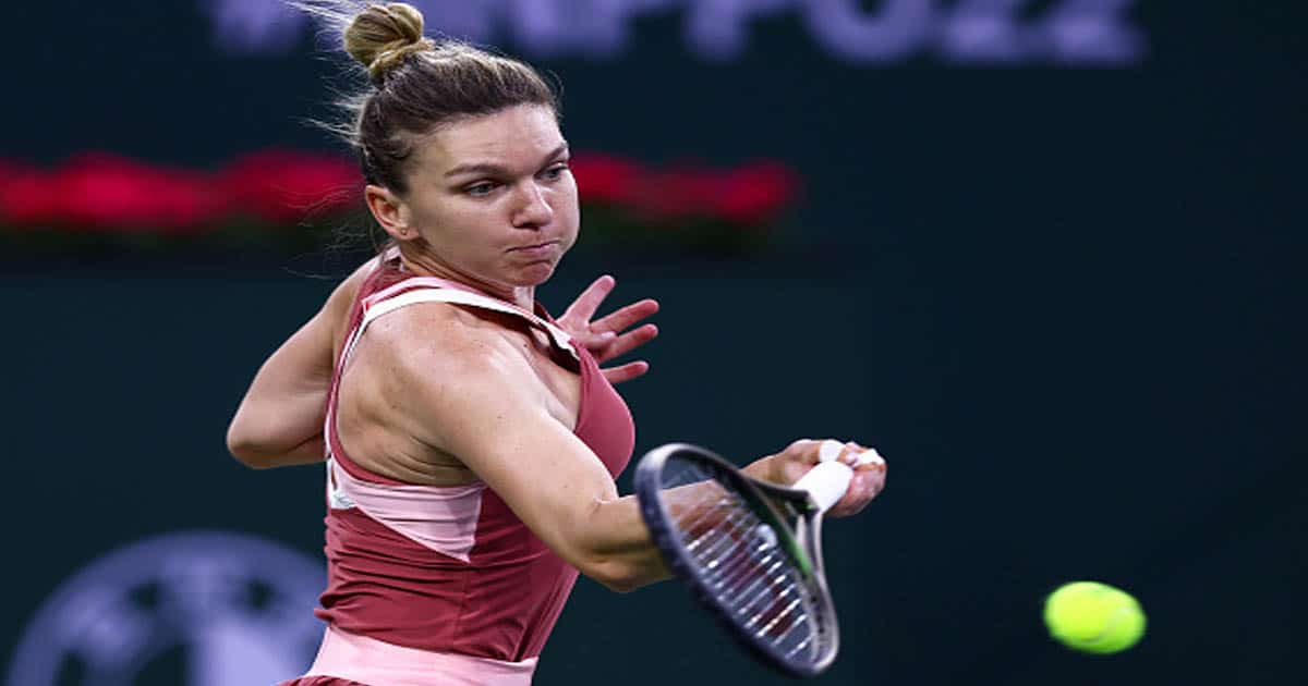 Simona Halep of Romania plays a forehand against Iga Swiatek of Poland