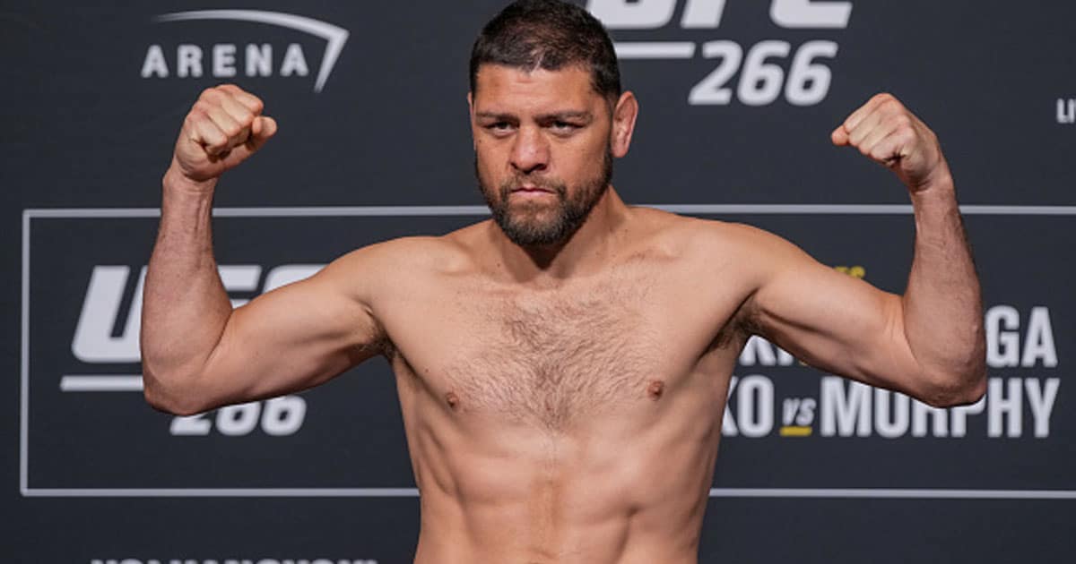 Nick Diaz steps on the scale for the official weigh prior for UFC 266