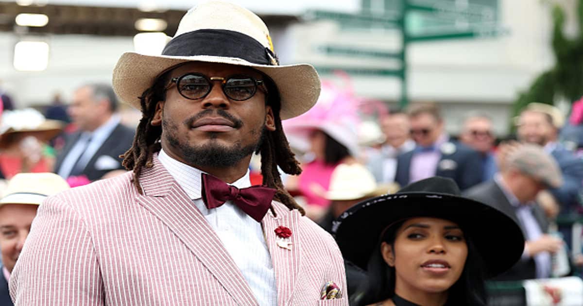 Cam Newton watches an undercard race before the running of the 148th Kentucky Derby