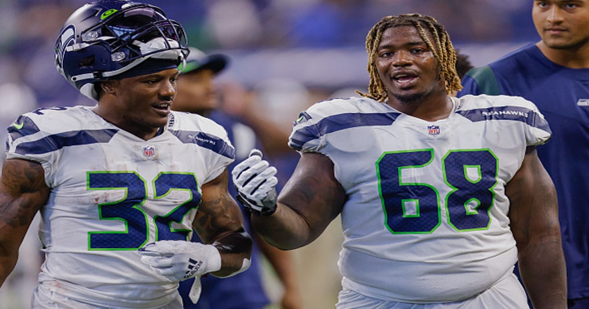 Chris Carson #32 and Damien Lewis #68 of the Seattle Seahawks are seen after the game against the Indianapolis Colts 