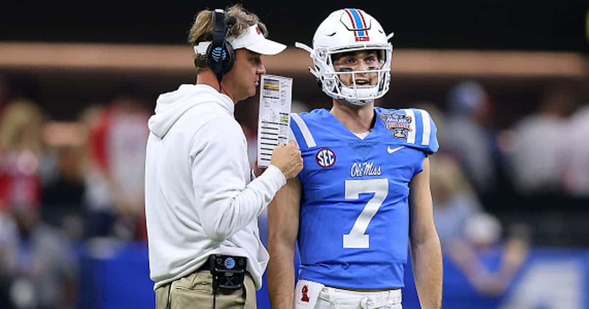 Lane Kiffin of the Mississippi Rebels talks with Luke Altmyer #7 against the Baylor Bears