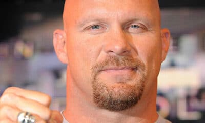 Stone Cold Steve Austin punches the air at the HMV store in central London