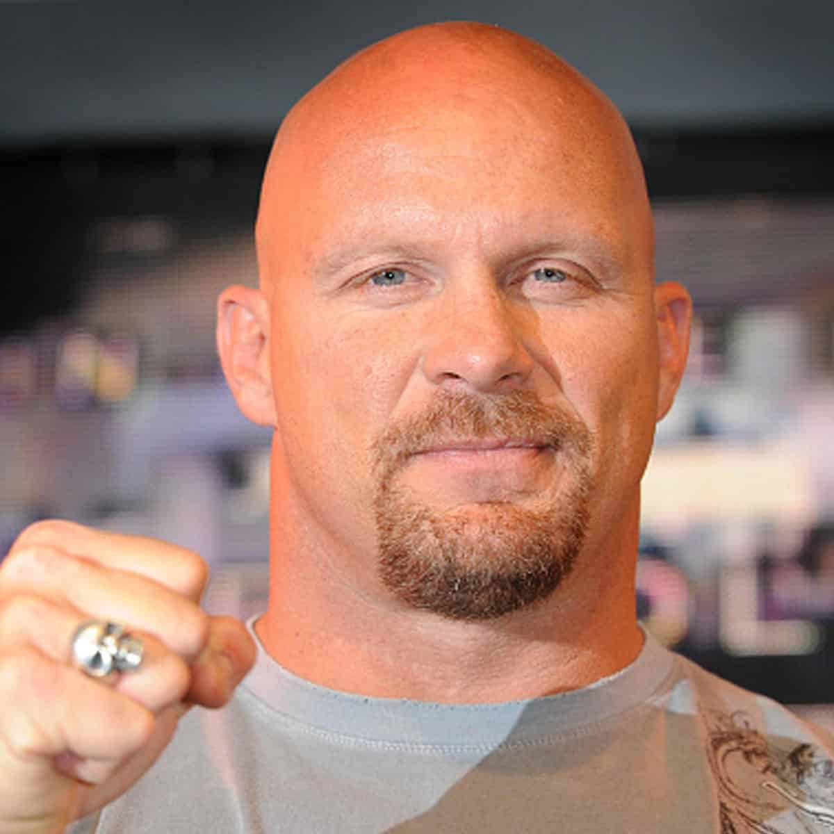 Stone Cold Steve Austin punches the air at the HMV store in central London